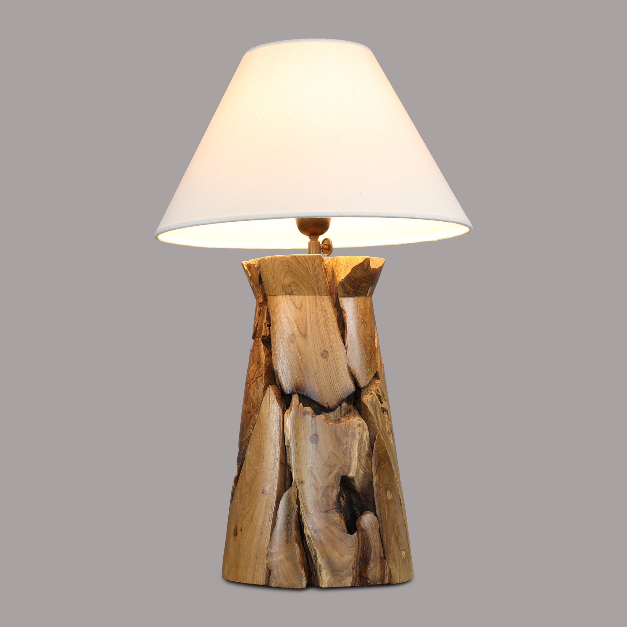 OXXY teak root table lamp on a grey background